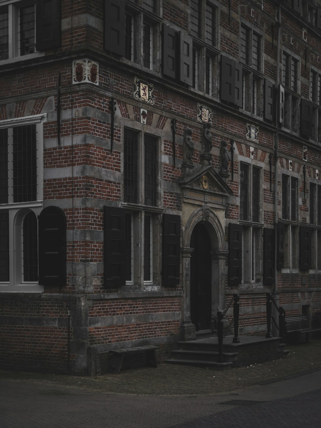 Dark cover illustration of an old stone building with a lit window at night for a mystery novel