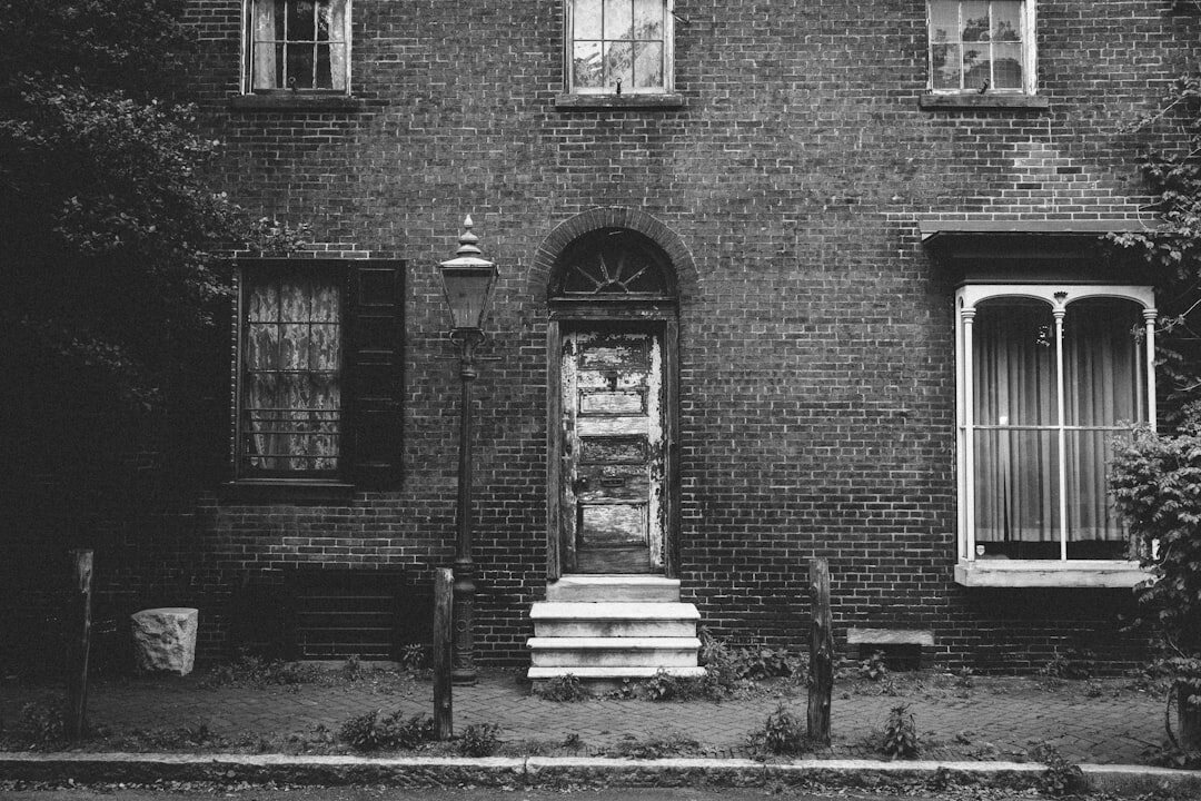 detective entering old house