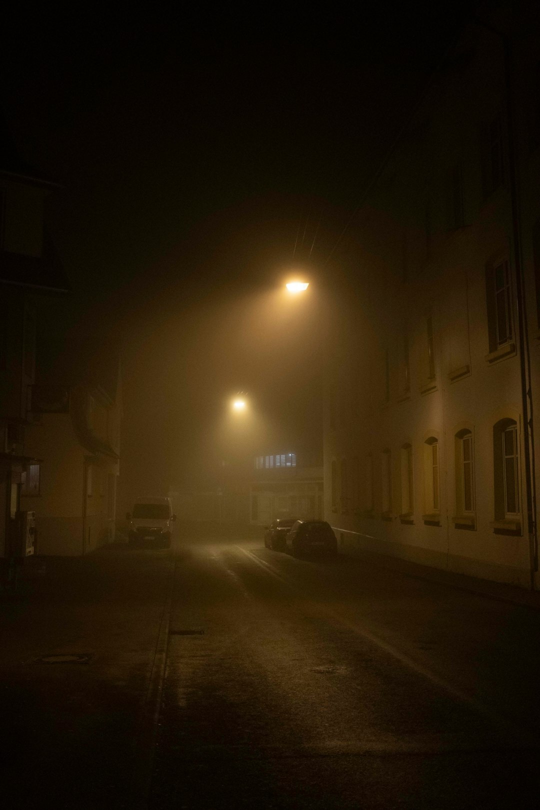 Dark moody cover illustration of a foggy street with a lone silhouette for a mystery novel